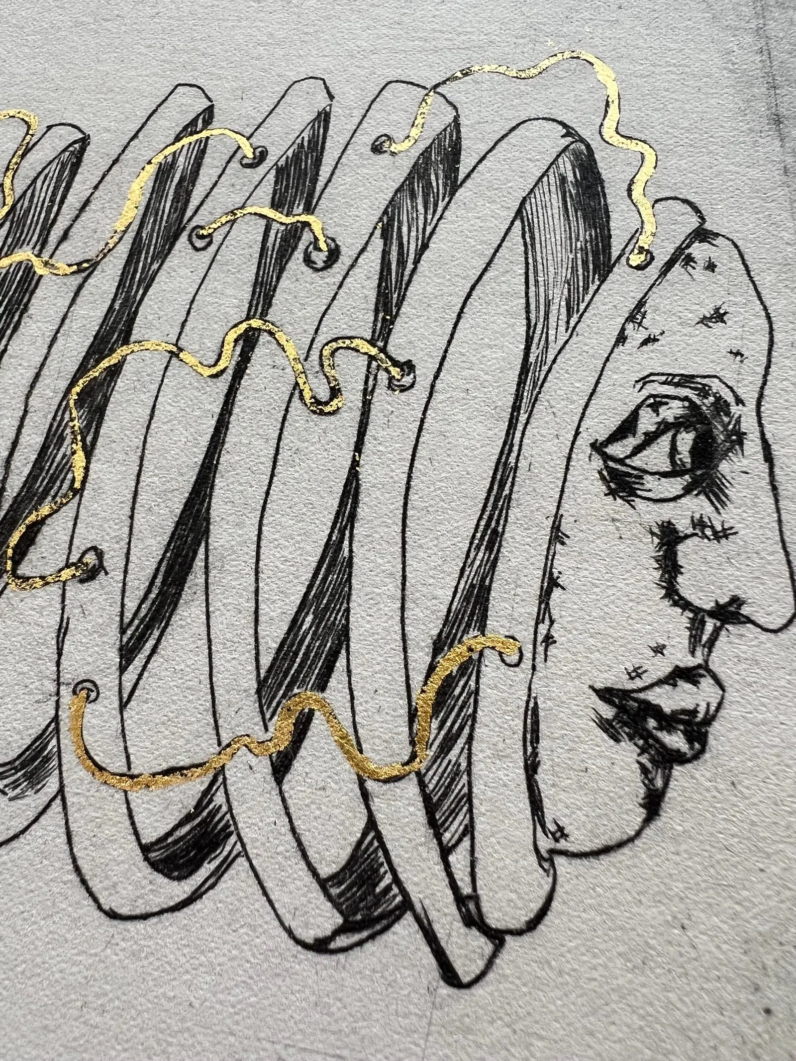 a line image of a face with a head pealed like an apple and gold leaf wires connecting the pieces together.